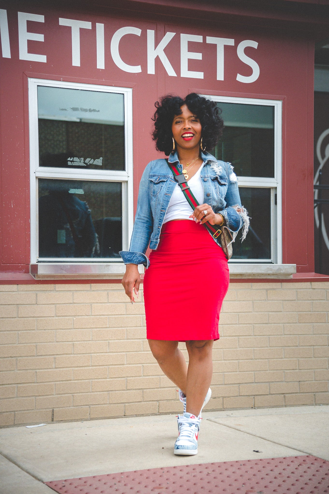 Woman In Red Crop Top And Grey Mini Skirt Holding Black Jacket · Free Stock  Photo